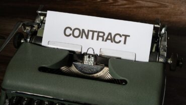 Et ark med teksten CONTRACT i en gammel skrivemaskin.