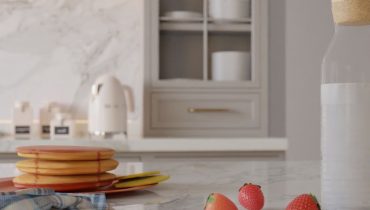 Et moderne kjøkken med fokus på et gullfarget håndtak på en skuff.