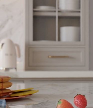 Et moderne kjøkken med fokus på et gullfarget håndtak på en skuff.